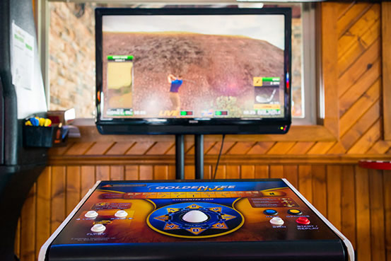 Video gaming machine showing golf simulation game on screen